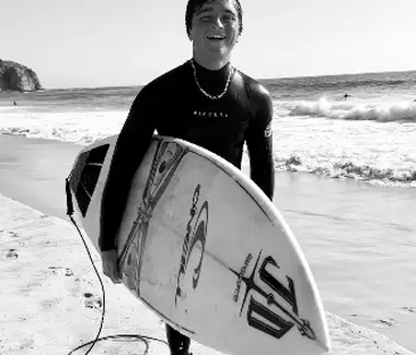 Surfer walking out of the ocean